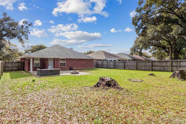 view of yard with an outdoor living space with a fire pit