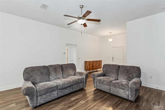 living room featuring ceiling fan and dark hardwood / wood-style flooring