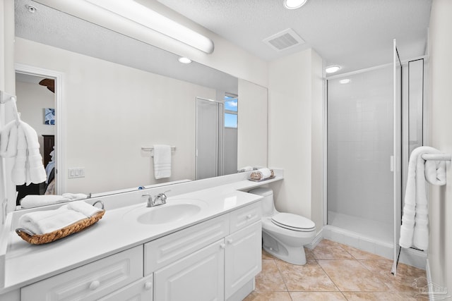 bathroom with tile patterned floors, an enclosed shower, a textured ceiling, toilet, and vanity