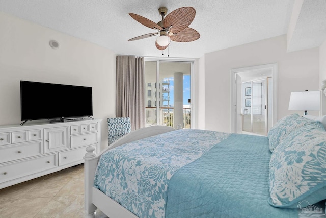 tiled bedroom with ceiling fan, a textured ceiling, and connected bathroom