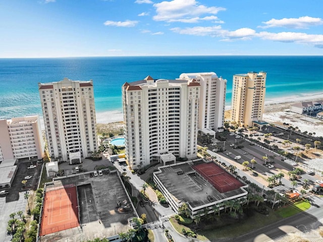 drone / aerial view featuring a beach view and a water view