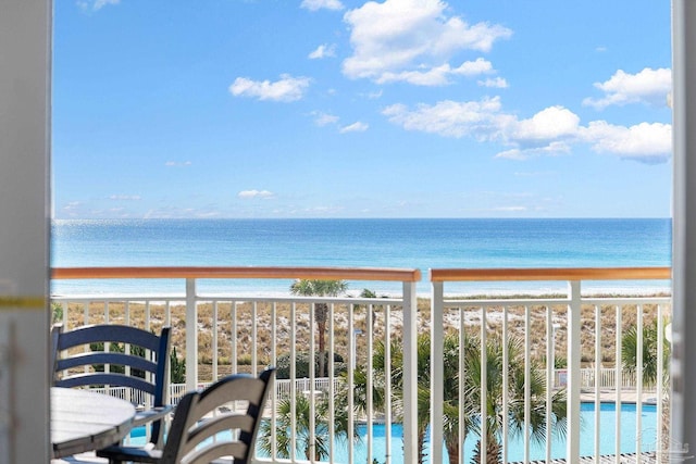 balcony with a beach view and a water view