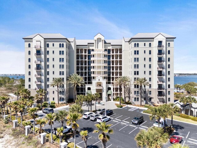 14900 River Rd Unit 306, Pensacola, FL 32507 - view of building exterior with uncovered parking and a water view