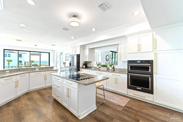 kitchen with white cabinetry, light stone countertops, and black appliances