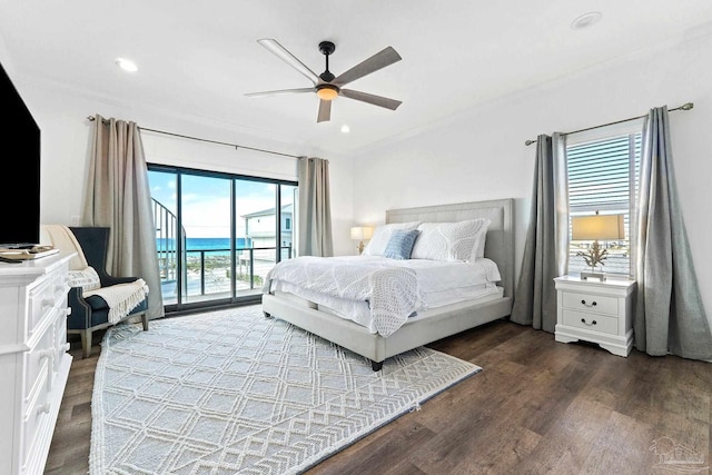 bedroom with dark hardwood / wood-style floors, access to outside, ceiling fan, crown molding, and a water view