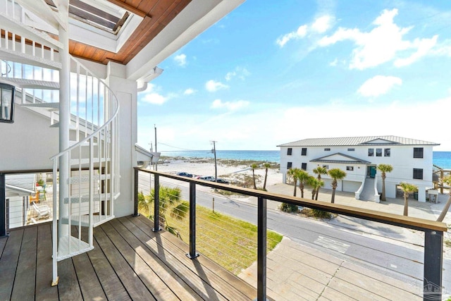 deck featuring a water view and a view of the beach