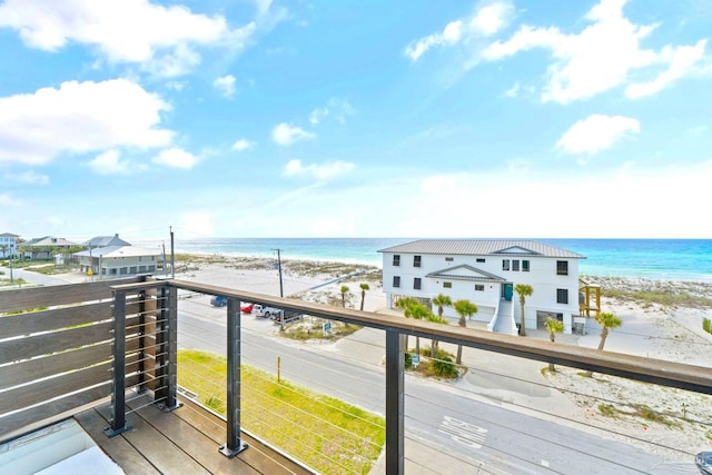 balcony with a water view and a beach view