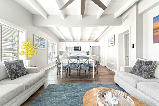 living room featuring dark hardwood / wood-style flooring, sink, and vaulted ceiling with beams