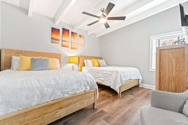 bedroom featuring lofted ceiling with beams, hardwood / wood-style floors, and ceiling fan