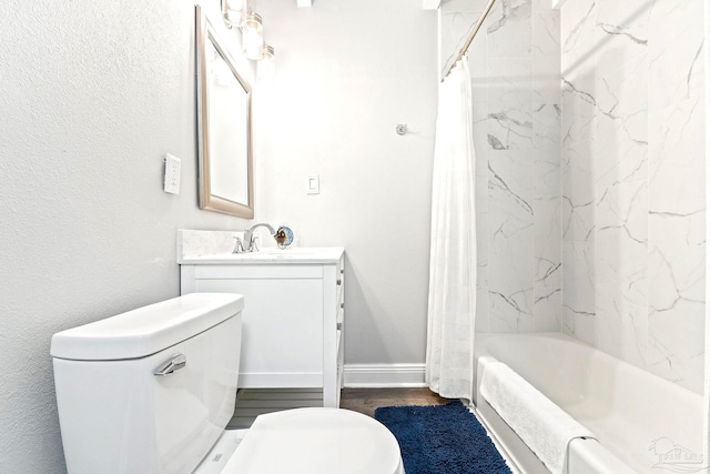 full bathroom featuring vanity, hardwood / wood-style floors, shower / bath combo with shower curtain, and toilet