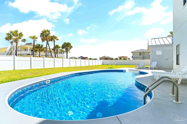 view of swimming pool with a patio area and a lawn