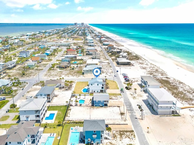 drone / aerial view featuring a view of the beach and a water view