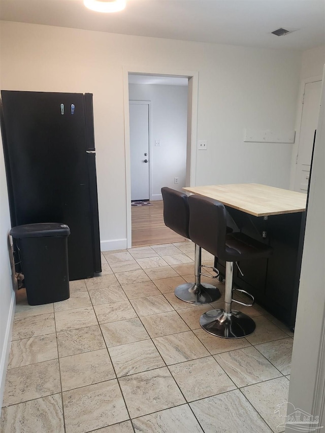 interior space with black refrigerator