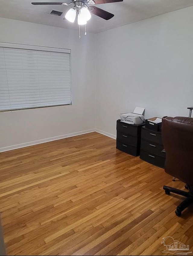 office with ceiling fan and light hardwood / wood-style flooring