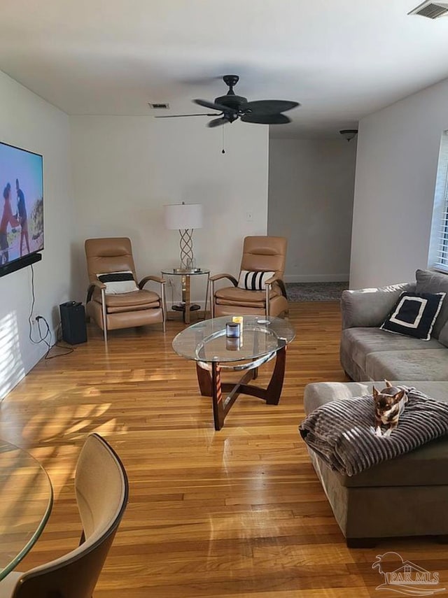 living room featuring ceiling fan and light wood-type flooring