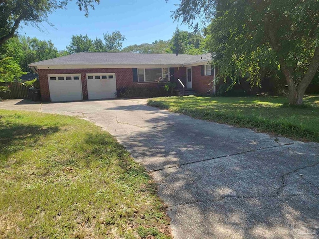 single story home featuring a garage and a front yard