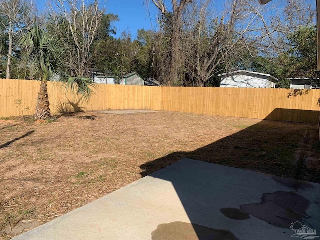 view of yard with a fenced backyard and a patio