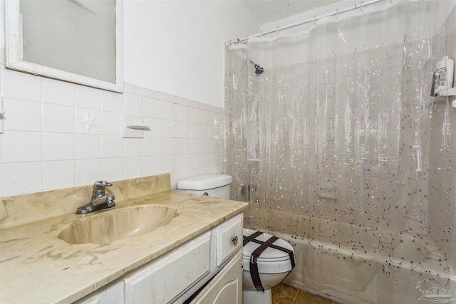 full bathroom featuring vanity, toilet, tile walls, and shower / bath combo