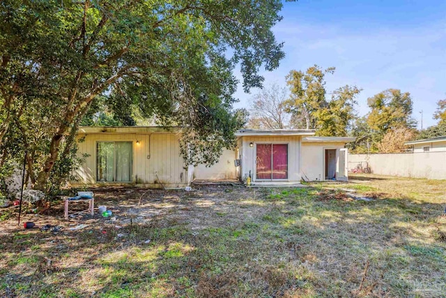 rear view of property with a yard