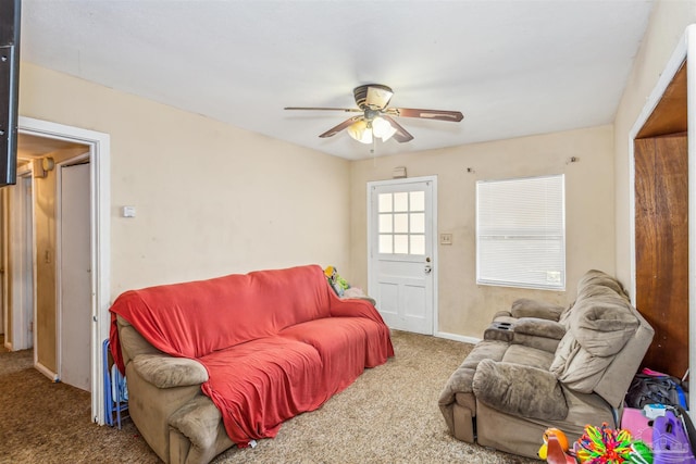 carpeted living room with ceiling fan