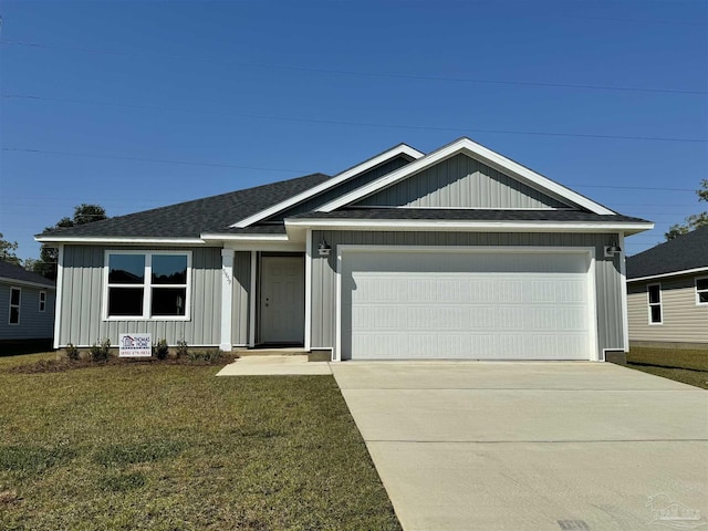 view of front of property with a garage and a front lawn