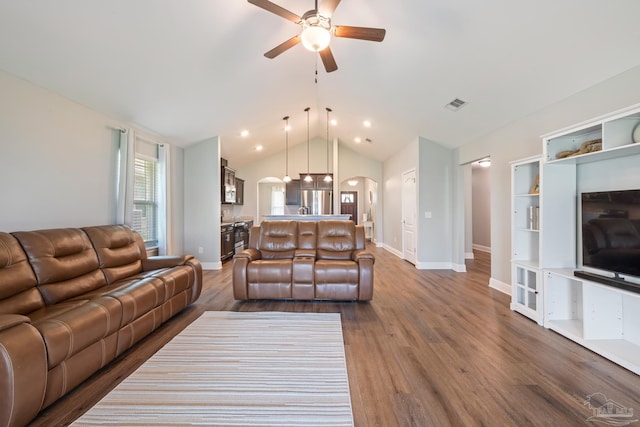 5726 Dunridge Dr, Pace, FL 32571 - living area with arched walkways, ceiling fan, lofted ceiling, baseboards, and wood finished floors