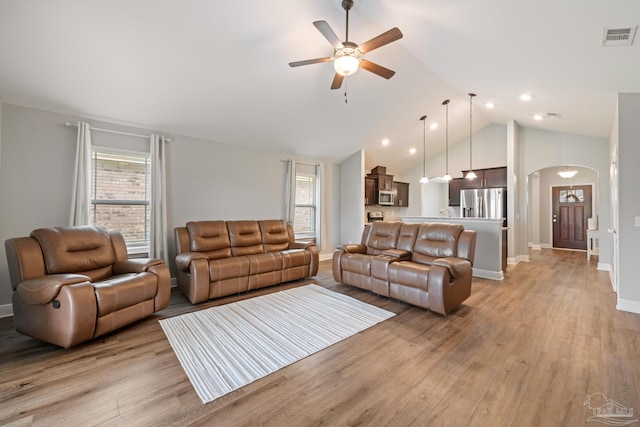5726 Dunridge Dr, Pace, FL 32571 - living area featuring arched walkways, ceiling fan, light wood finished floors, lofted ceiling, and baseboards