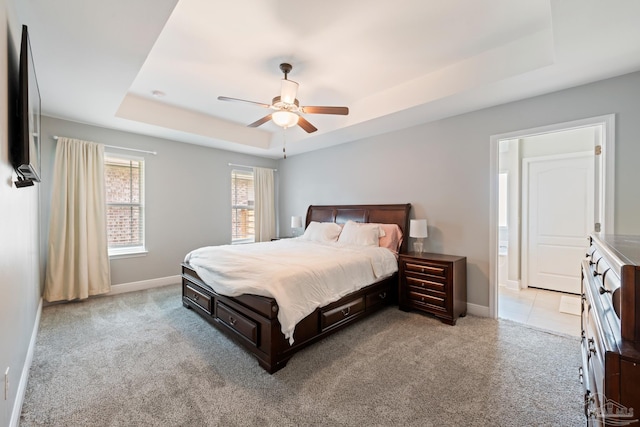 5726 Dunridge Dr, Pace, FL 32571 - carpeted bedroom featuring a tray ceiling, baseboards, and ceiling fan