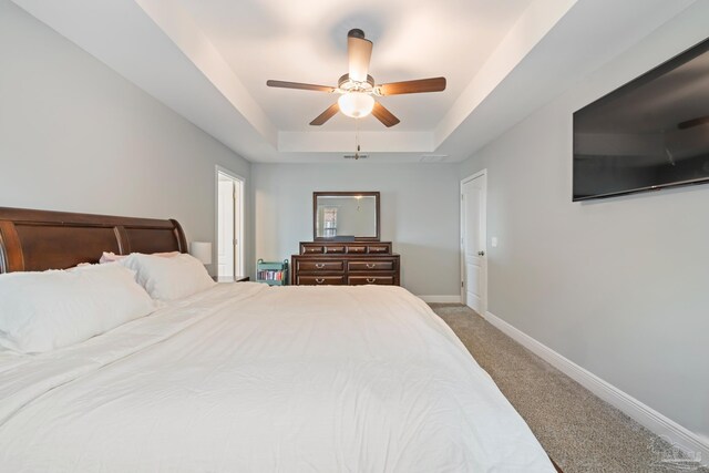 5726 Dunridge Dr, Pace, FL 32571 - bedroom with carpet floors, a tray ceiling, baseboards, and ceiling fan