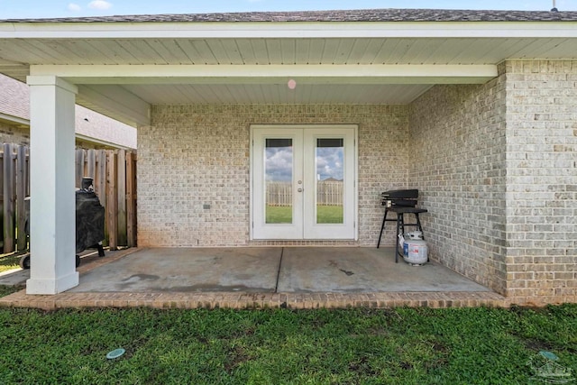 5726 Dunridge Dr, Pace, FL 32571 - entrance to property with french doors, brick siding, and a patio