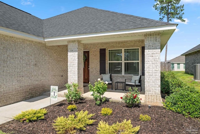 5726 Dunridge Dr, Pace, FL 32571 - view of exterior entry with covered porch, roof with shingles, and brick siding
