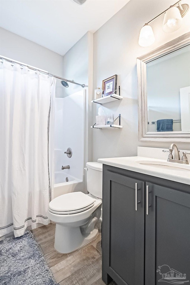 full bathroom featuring vanity, shower / bath combo, and toilet