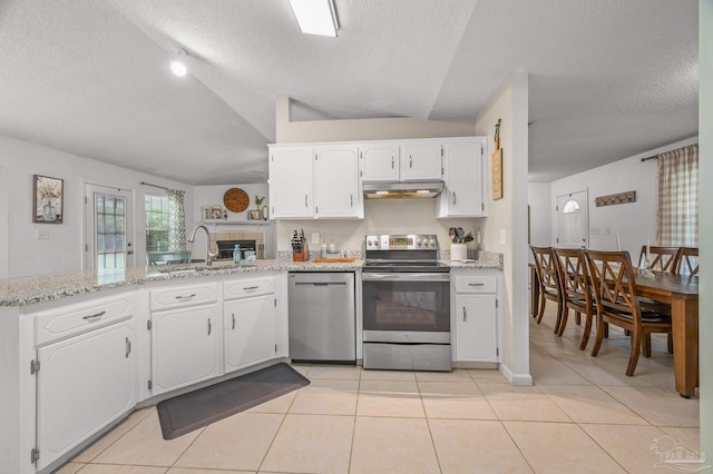 kitchen featuring light tile patterned floors, a sink, stainless steel appliances, and under cabinet range hood