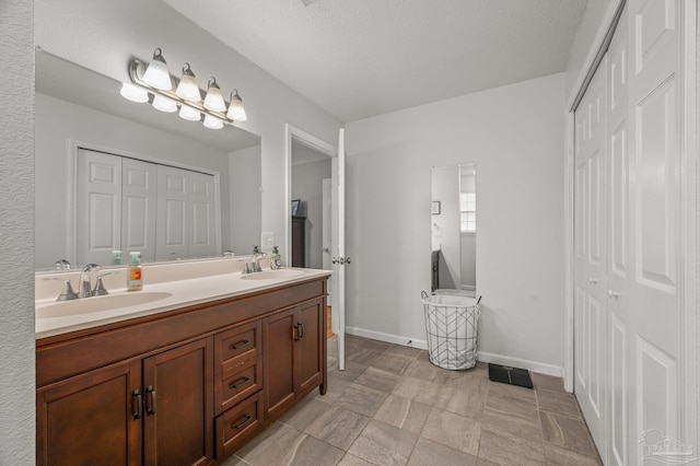 bathroom with a sink, a closet, and visible vents
