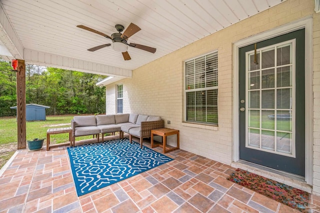 view of patio / terrace with an outdoor hangout area, a storage unit, an outdoor structure, and ceiling fan