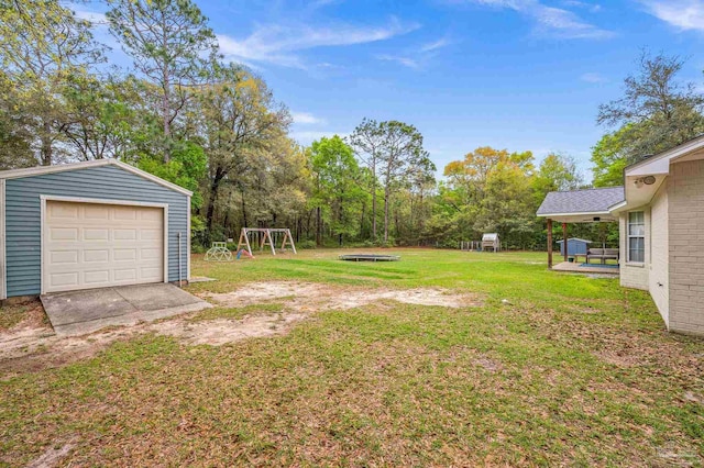 view of yard featuring an outbuilding and a detached garage