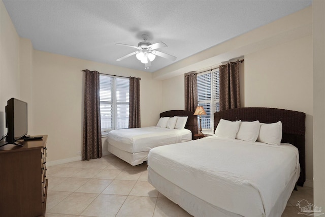 bedroom featuring light tile patterned floors, a textured ceiling, and ceiling fan