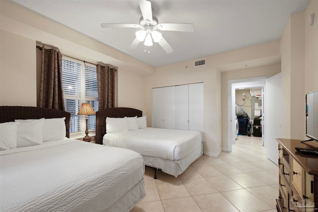 tiled bedroom with a closet and ceiling fan