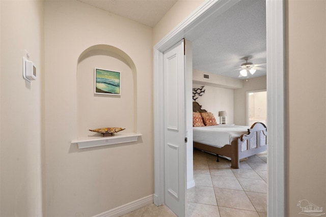 hall featuring light tile patterned floors