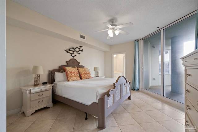 tiled bedroom with ceiling fan, access to exterior, and a textured ceiling