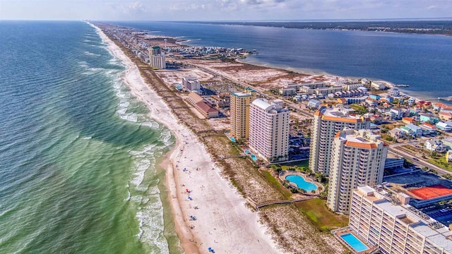 bird's eye view with a water view and a beach view