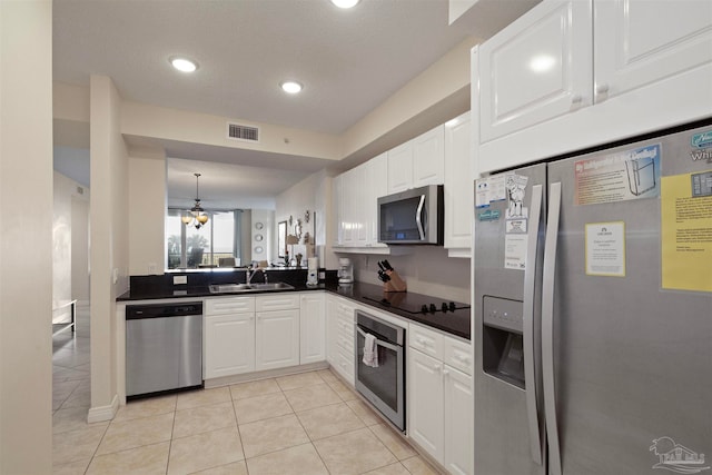 kitchen with white cabinetry, sink, pendant lighting, light tile patterned flooring, and appliances with stainless steel finishes