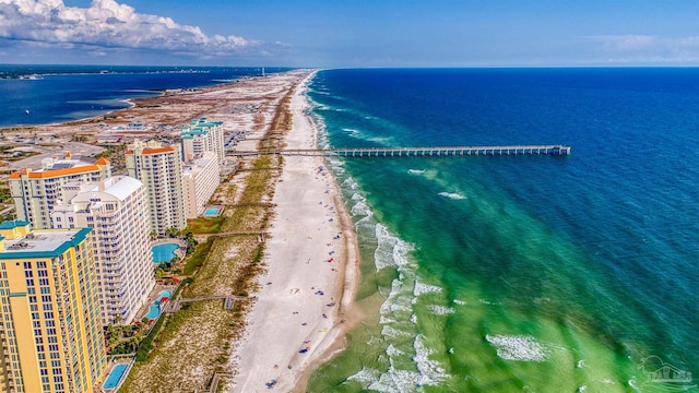 birds eye view of property with a water view and a beach view