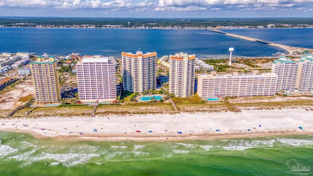 bird's eye view with a water view and a beach view