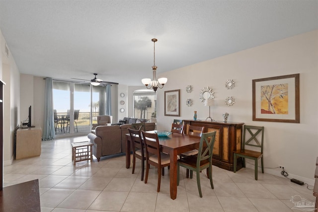 dining room featuring a textured ceiling, light tile patterned floors, and ceiling fan with notable chandelier