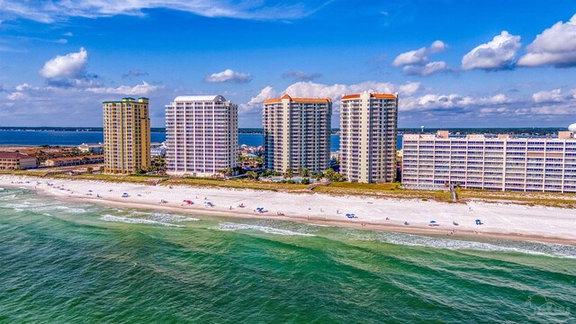 birds eye view of property with a water view and a view of the beach