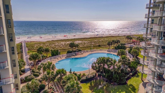 view of pool with a beach view and a water view