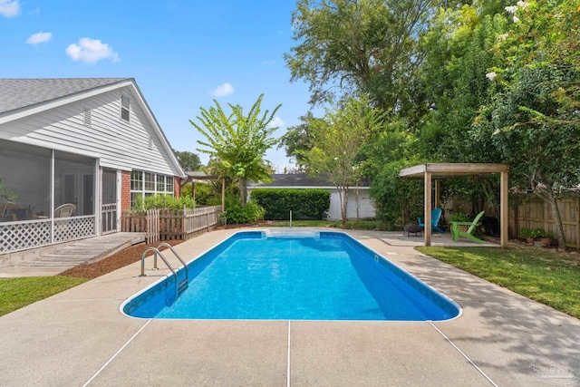 view of swimming pool with a patio and a sunroom