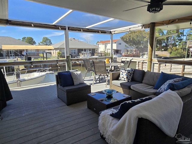 wooden deck with a residential view, an outdoor hangout area, and a ceiling fan