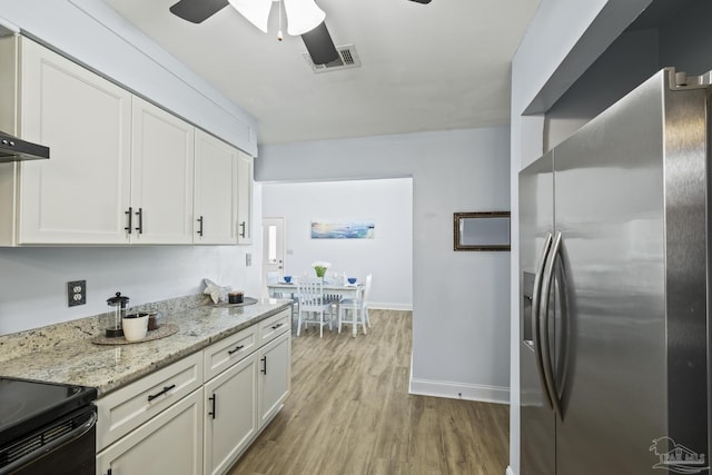 kitchen featuring light wood finished floors, white cabinetry, visible vents, and stainless steel fridge with ice dispenser